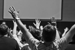 Christians raising hands and singing during a worship service at Sojourn New Albany church