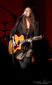 Singer-songwriter Tara-Leigh Cobble performing live with her guitar