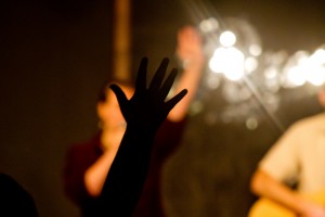 Hand raised in adoration during Christian worship service at Sojourn Community Church