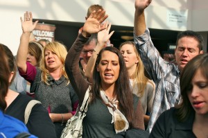 Praise & Thanksgiving with hands raised at Sojourn Community church baptism service