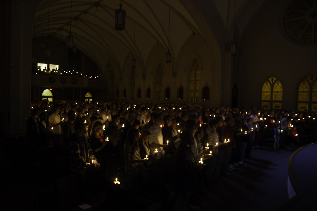Sojourn Church worshipers holding candles in the darkened St. Vincent's cathedrals