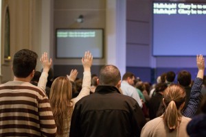 Hands raised in Christian worship service at Sojourn Community Church