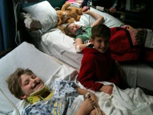 Collin (middle) visits his siblings Caleb & Mia Gilles in the hospital yesterday.