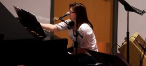 Kristen Gilles arranging music at the piano at Sojourn J-Town. Photo by Tom Branch