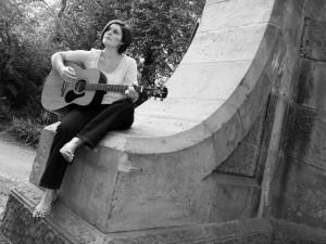 Kristen Gilles playing guitar outdoors