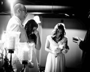 Laughter on stage during wedding ceremony of Bobby and Kristen Gilles, officiated by Pastor Mike Cosper