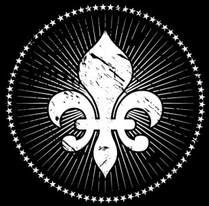 Sojourn fleur-de-lis in reverse type (white mark, black background). We also use it as a black mark on white background