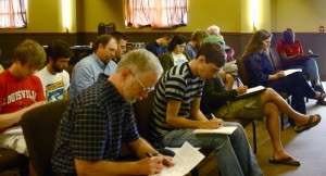 Writers work at a songwriting workshop at our church, Sojourn